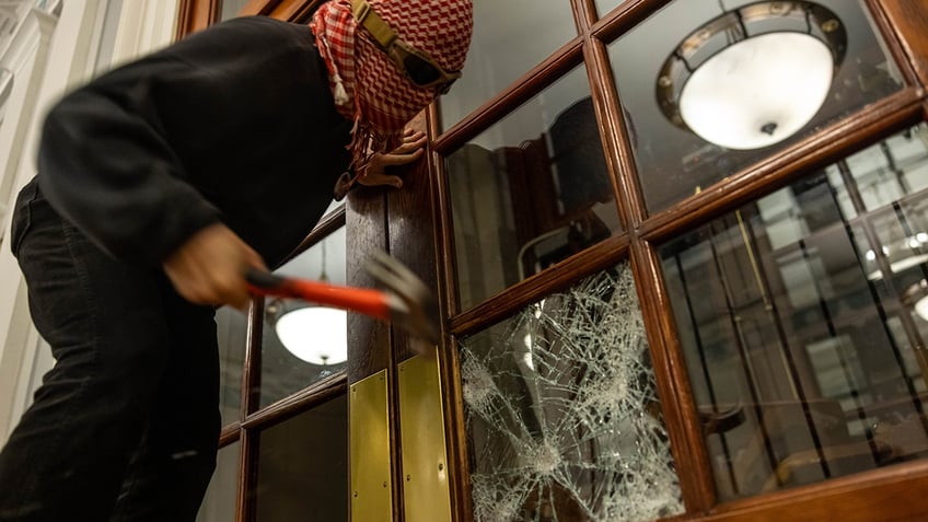 Protester smashing window