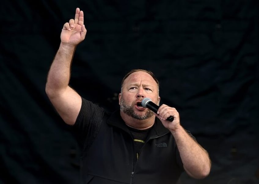 US far-right radio show Alex Jones speaks to supporters of US President Donald Trump as th