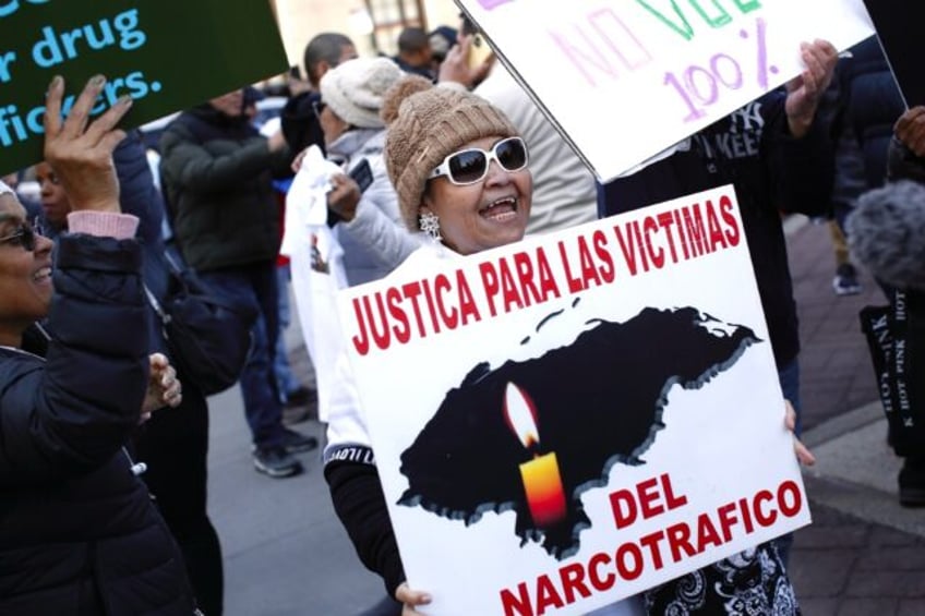 People react outside the Manhattan federal court after a jury found former Honduran presid