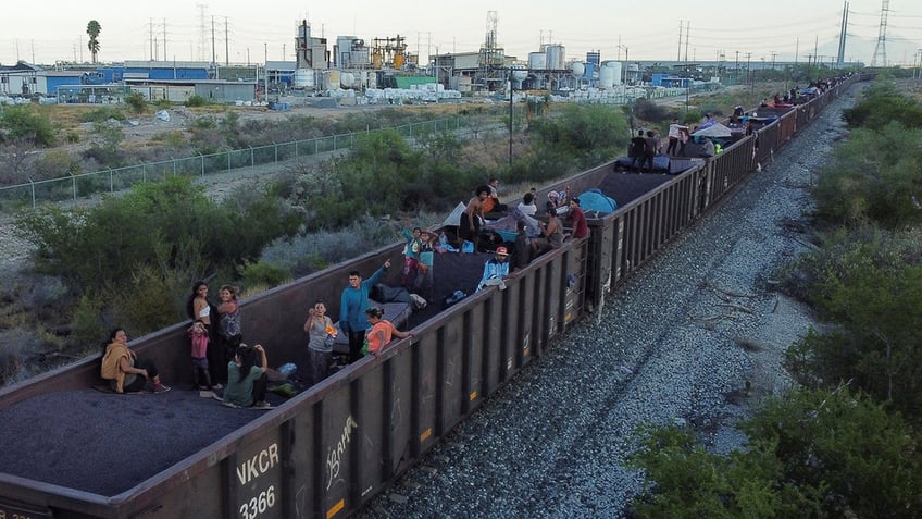 Asylum seekers heading to the U.S. travel on a train, in El Carmen