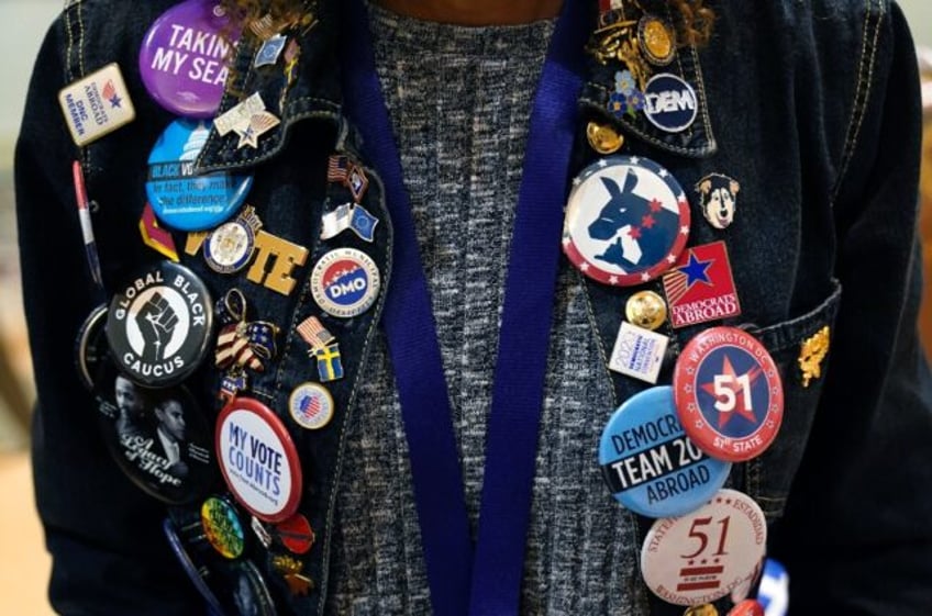 A Democratic activist shows off his pins at the Democratic National Committee's winter con