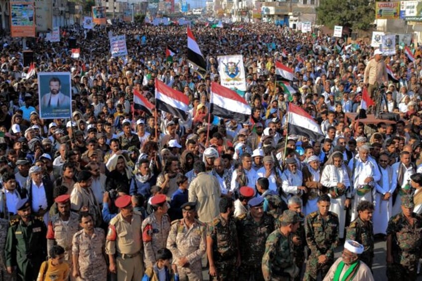 People take part in a protest in the streets of the Yemeni Red Sea city of Hudeida, to condemn US and British strikes on Huthi rebel-held cities, on January 12, 2024