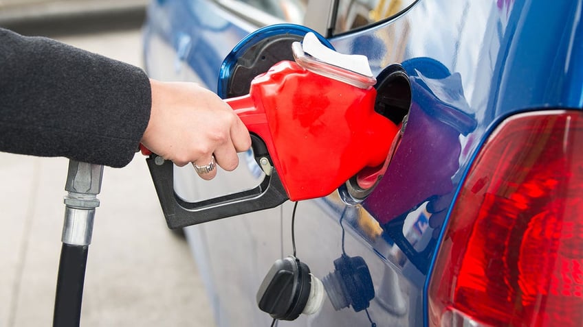 Woman pumping gas