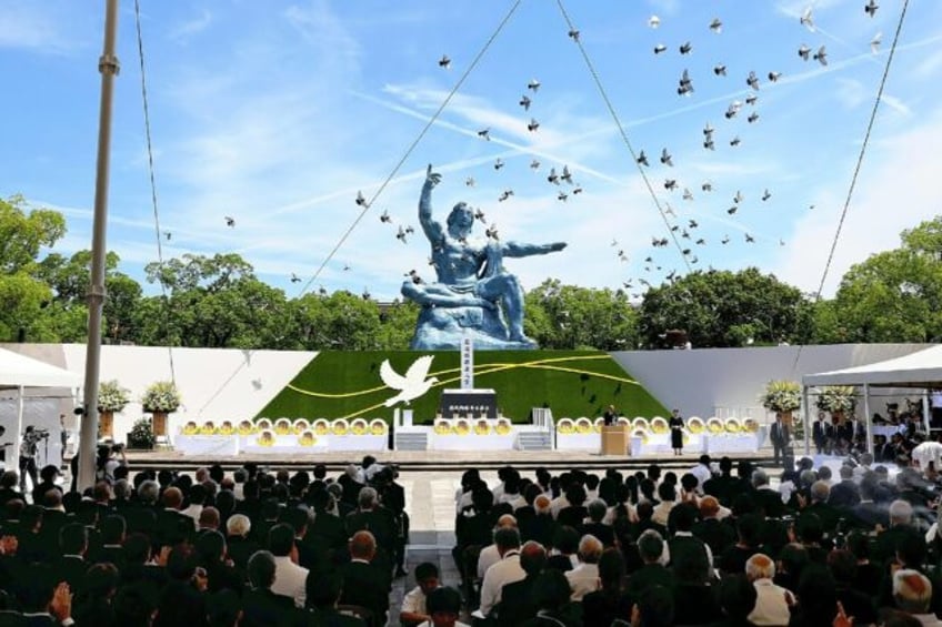 Pigeons are released during a peace prayer ceremony at the Peace Park in Nagasaki on Augus