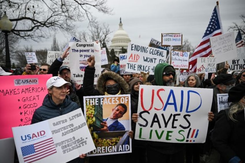 People protest near the US Capitol against the Trump administration's decision to virtuall