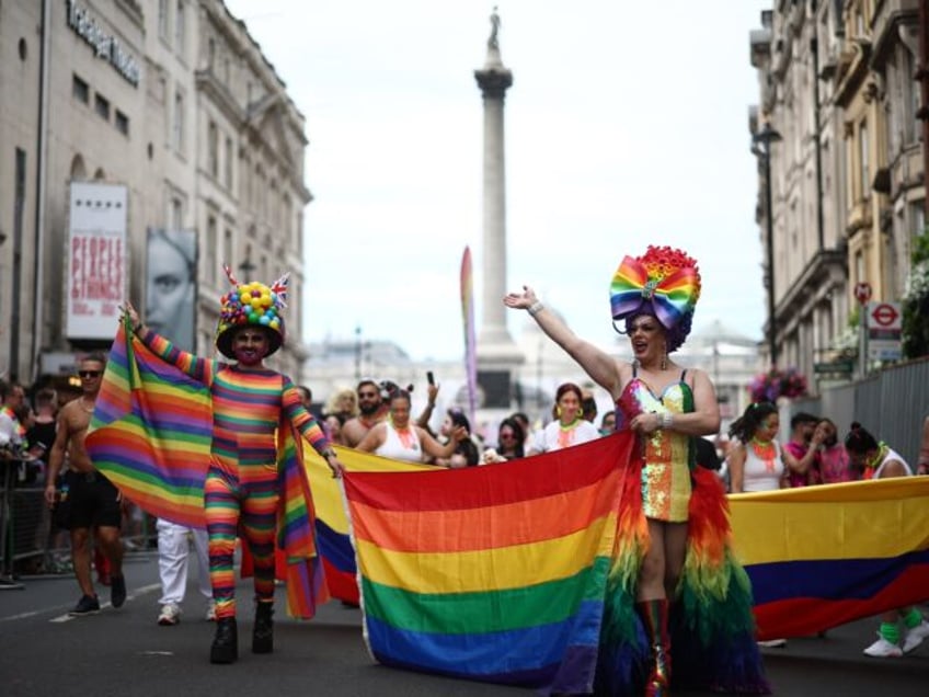 Members of the public watch as members of the Lesbian, Gay, Bisexual and Transgender (LGBT