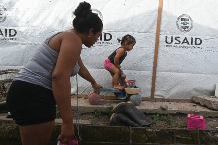 Sandra Ramos plays with her daughterat an improvised shack built with the help of the US A