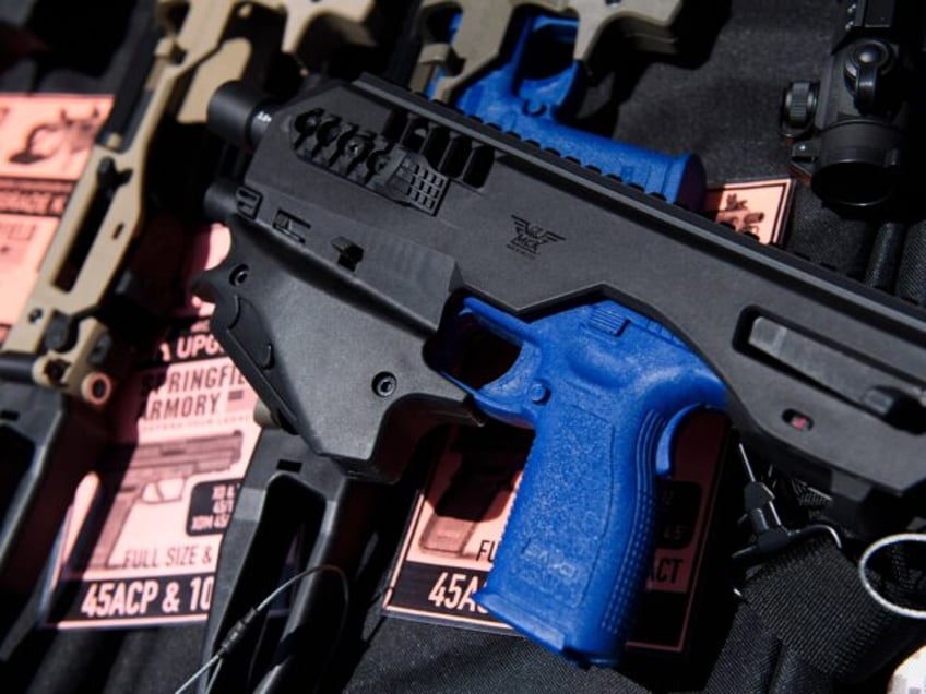 A MCK pistol brace for a handgun is displayed with firearm accessories for sale at the Cro