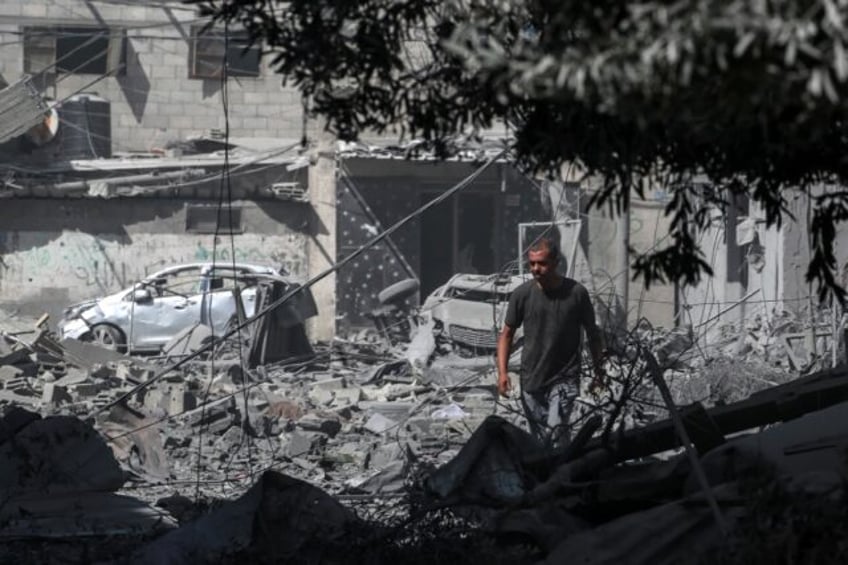 A Palestinian looks at the debris from fighting following the hostage rescue operation by