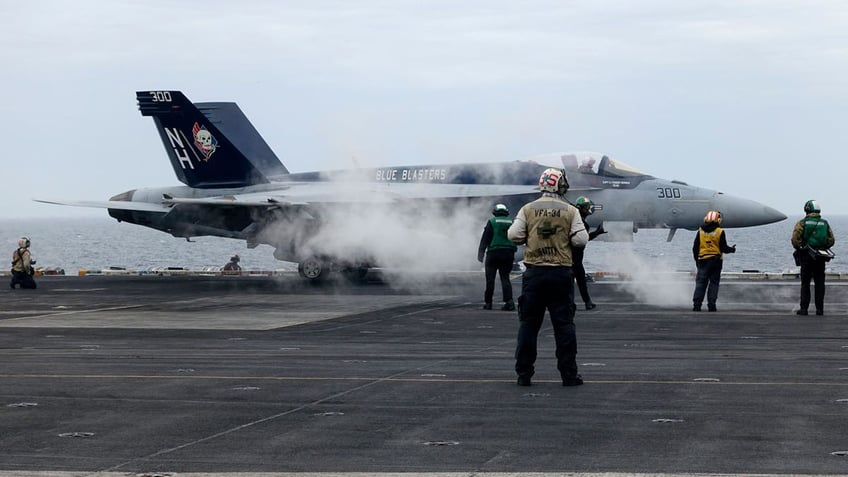 A F-18E fighter jet prepares to take off from USS Theodore Roosevelt aircraft carrier