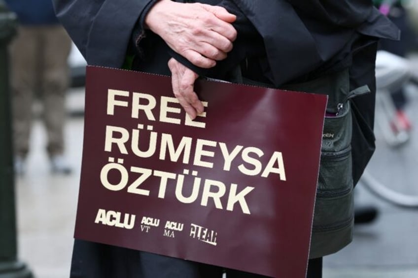 A protestor holds a sign at a rally in New York in support of Tufts University student Rum