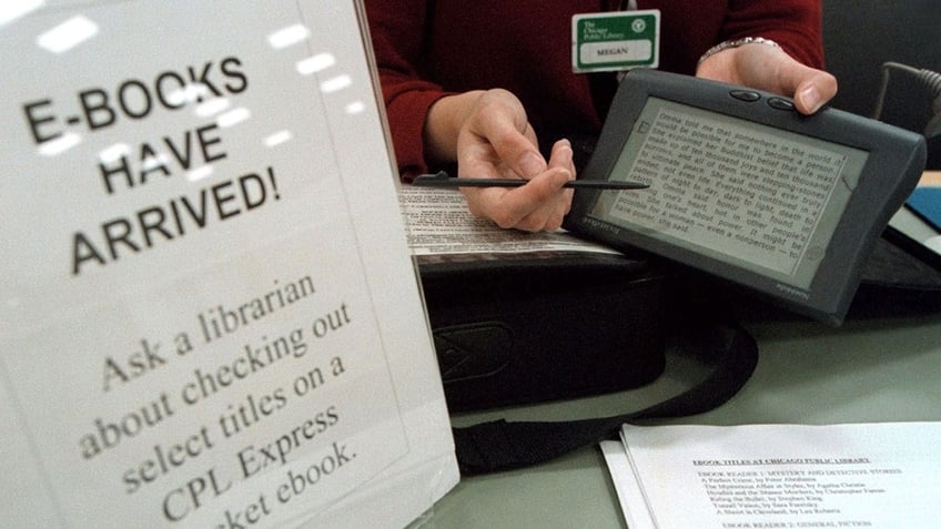 Librarian holding e-book