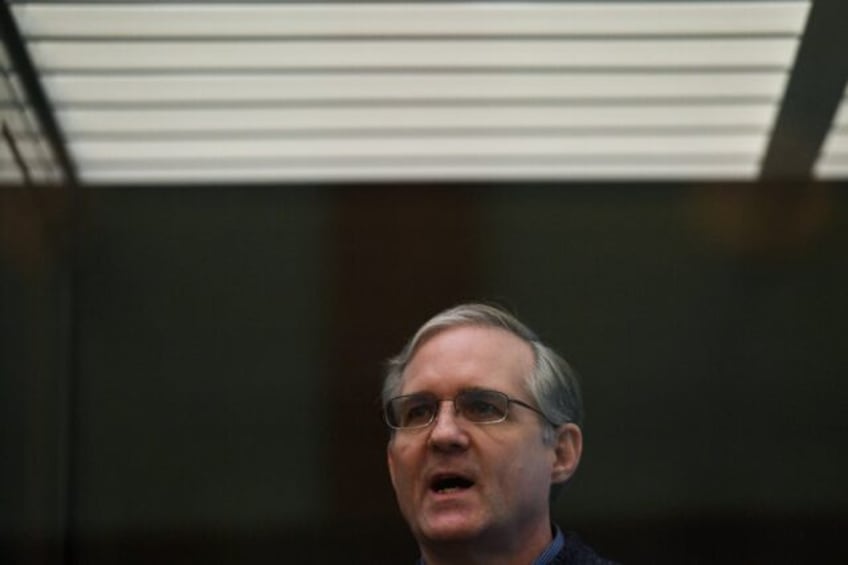 Paul Whelan stands inside a defendants' cage as he waits to hear his verdict in Moscow in June 2020