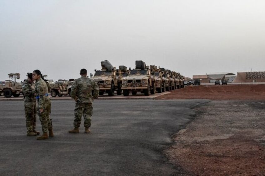 Military vehicles that will be boarded onto a cargo plane as part of US troops' departure