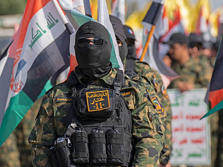 Supporters of Iraqi Hezbollah brigades attend a rally in military uniforms on the annual A