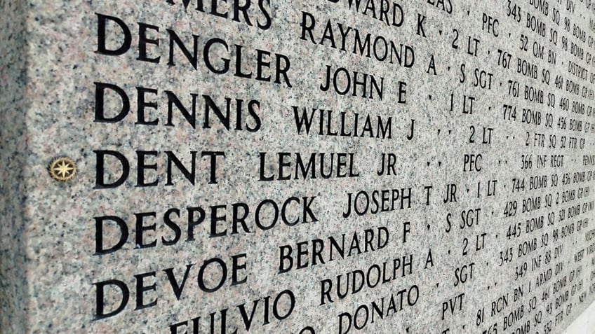 A rosette is seen next to the name of Dent Lemuel Jr. in Florence American Cemetery in Italy.