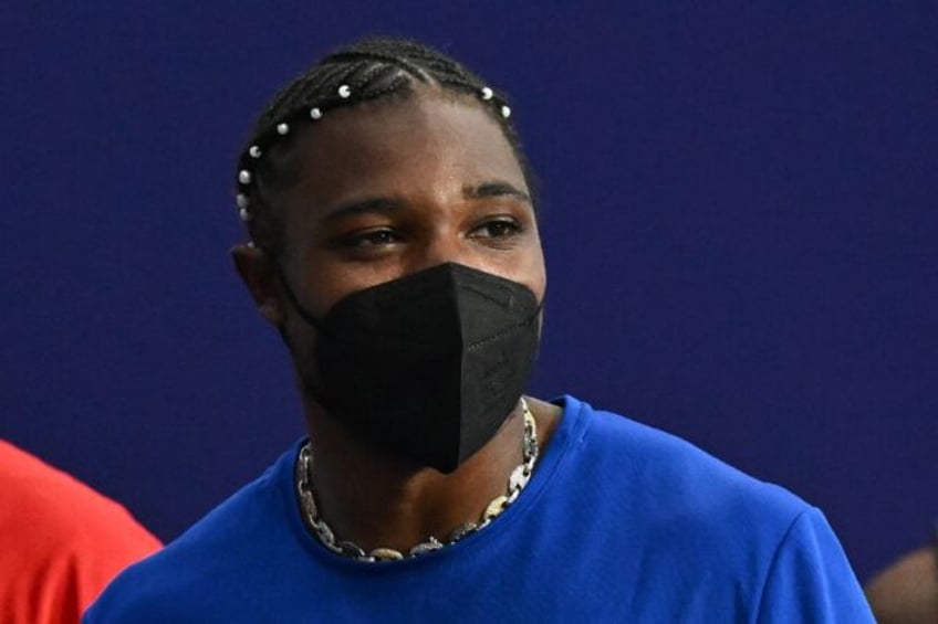 Noah Lyles is seen wearing a mask after finishing third in the 200 metres - he said he tes