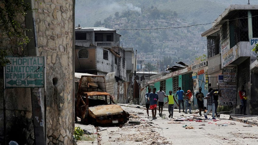 Damaged car in Haiti neighborhood