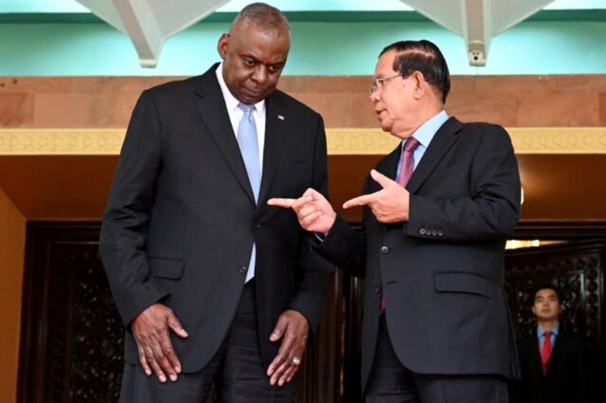 Defense Secretary Lloyd Austin (L with Cambodia's long-serving former prime minister Hun S