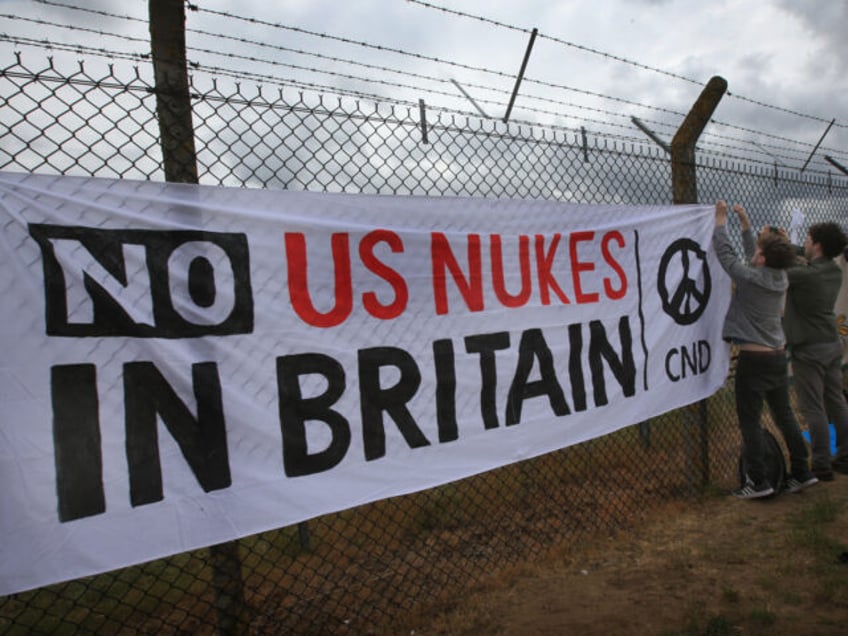 LAKENHEATH, ENGLAND - MAY 21: Various flags and banners supporting CND and peace are fixed to the air base's fence on May 21, 2022 in Lakenheath, England. The demonstration is to protest against reports that the US intends to resite nuclear bombs at the base. After sustained protest nuclear weapons …