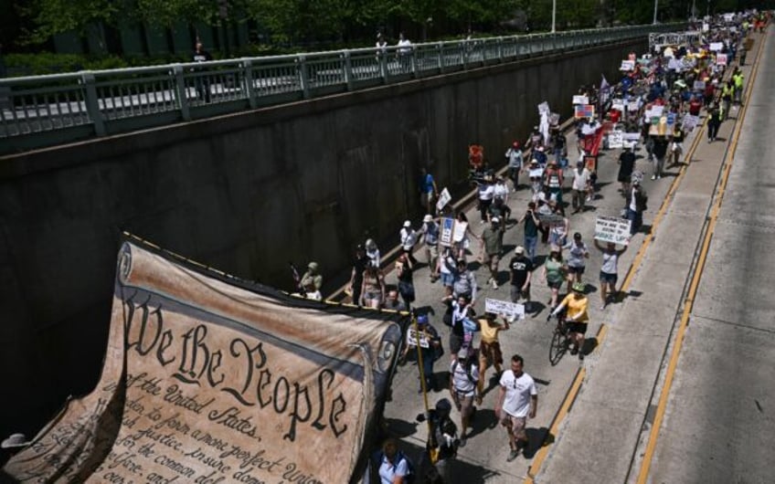 Protesters carry a replica of the Declaration of Independence as they march through Washin