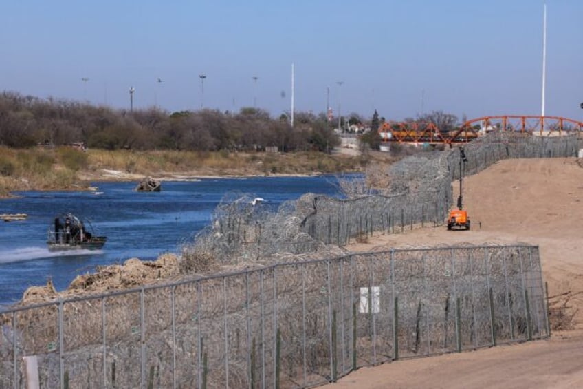 A US Border Patrol officer deploys on the Rio Grande on the US-Mexico border at Eagle Pass