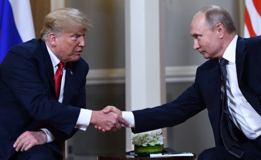 Former US president Donald Trump (L), seen shaking hands with Russian President Vladimir P