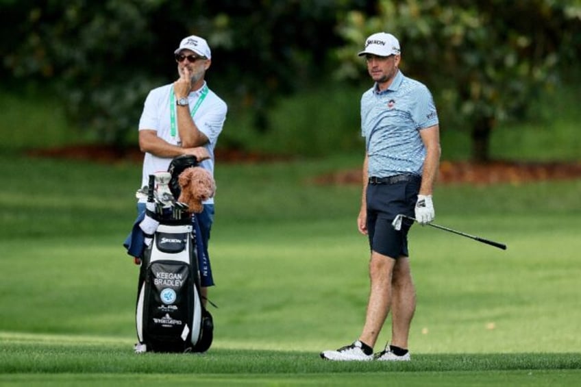 US 2025 Ryder Cup captain Keegan Bradley, right, watches a shot with caddie Scott Vail jus
