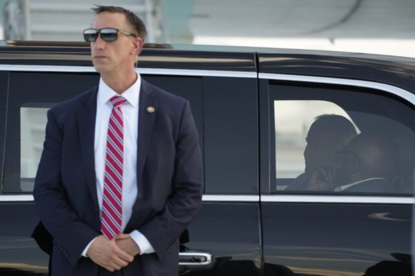 A Secret Service agent stands guard outside President Joe Biden's motorcade in Las Vegas,