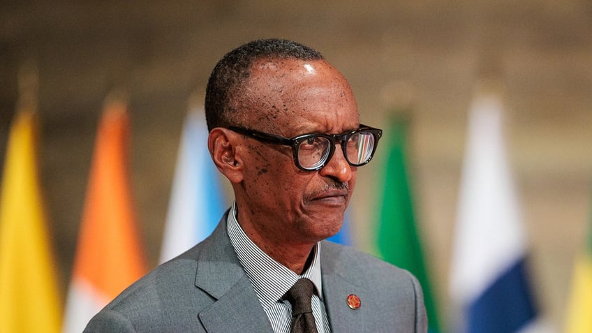 Paul Kagame looks on