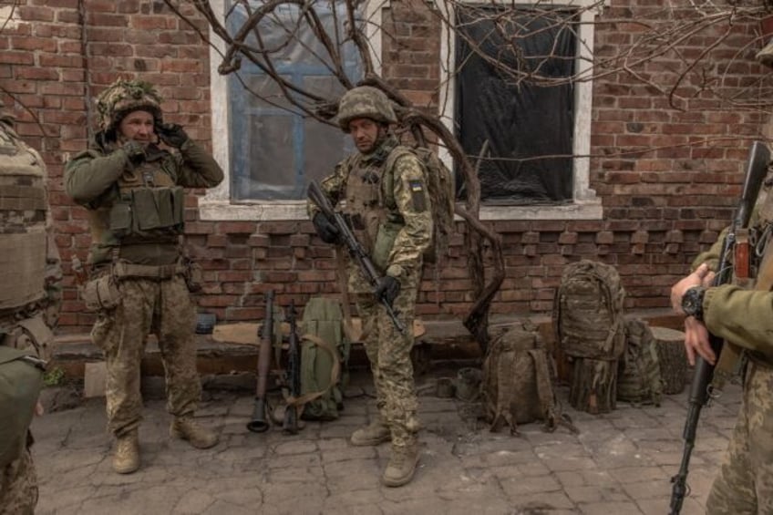 Ukrainian soldiers from the 23rd Mechanized Brigade prepare to head toward the frontline i