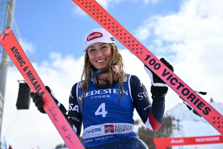 Mikaela Shiffrin poses with skis marking her "100 Victories"