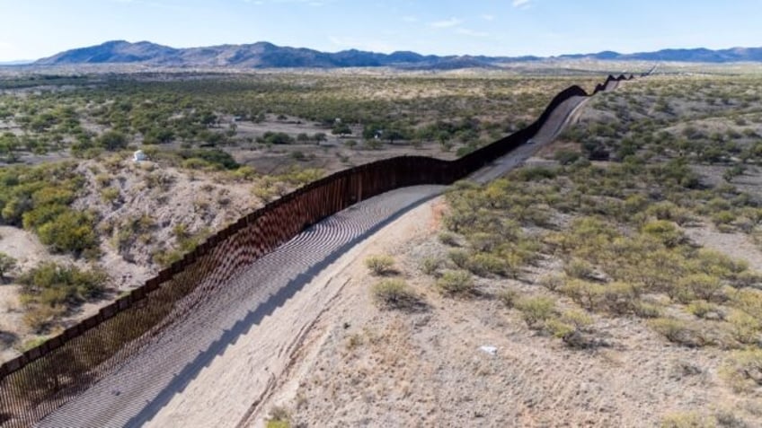 This aerial picture taken on December 8, 2023 shows the US-Mexico border wall in Sasabe, Arizona