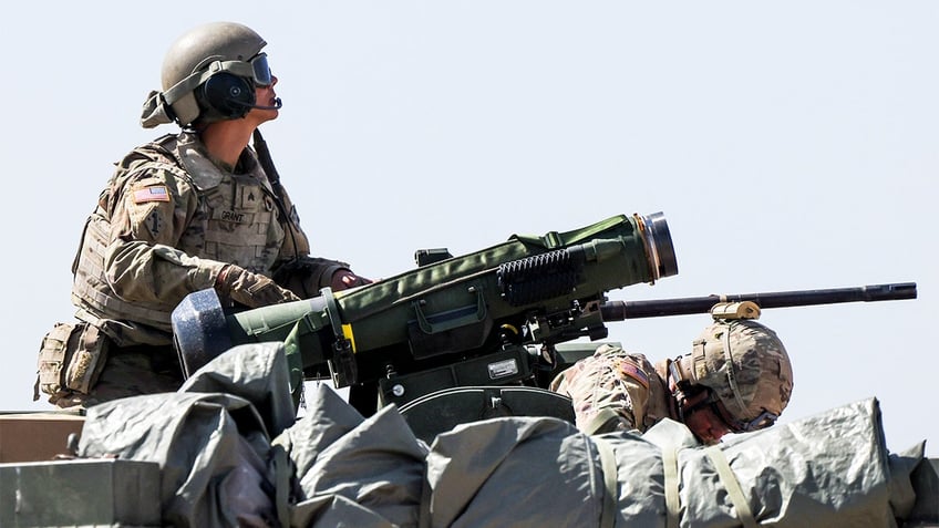 A soldier with the 2nd Stryker Brigade Combat Team stands next to a Javelin missile loaded onto a Stryker Infantry Carrier Vehicle before a live-fire training exercise on April 28, 2022 in Fort Carson, Colorado. (Photo by Michael Ciaglo/Getty Images)