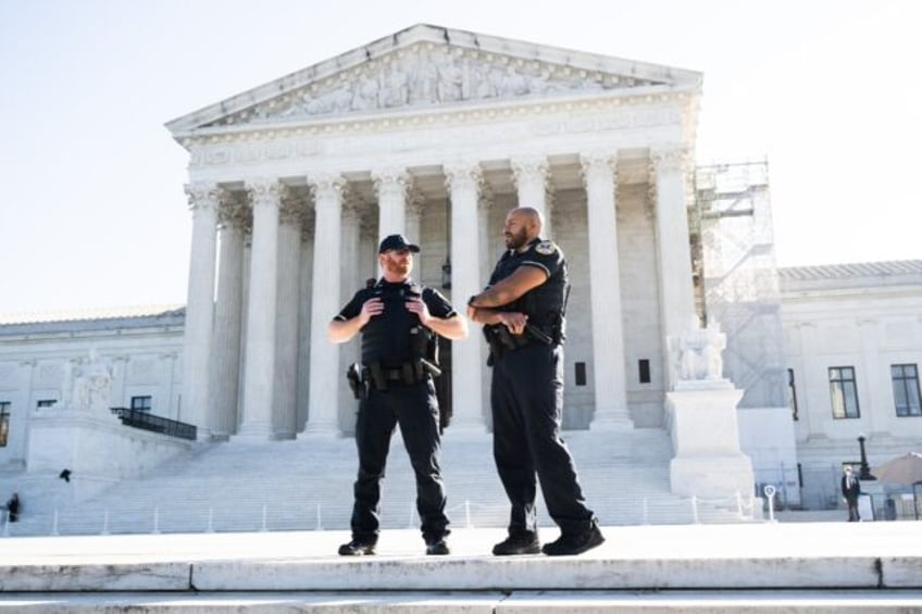 Police officers outside the US Supreme Court as it begins its 2024 fall term