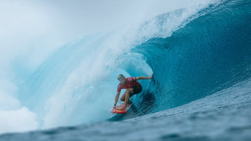 John John Florence surfs