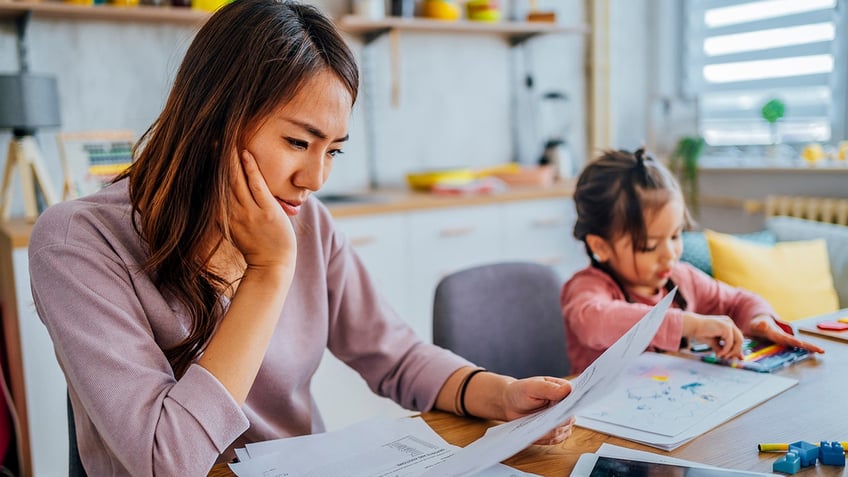 stressed mother checking her finances