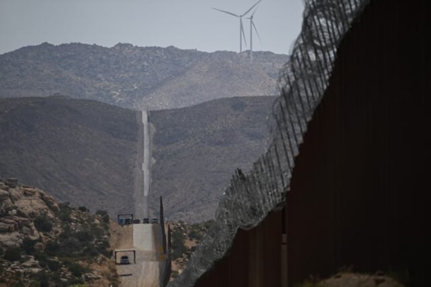 The border wall between the United States and Mexico is seen from Jacumba Hot Springs, Cal