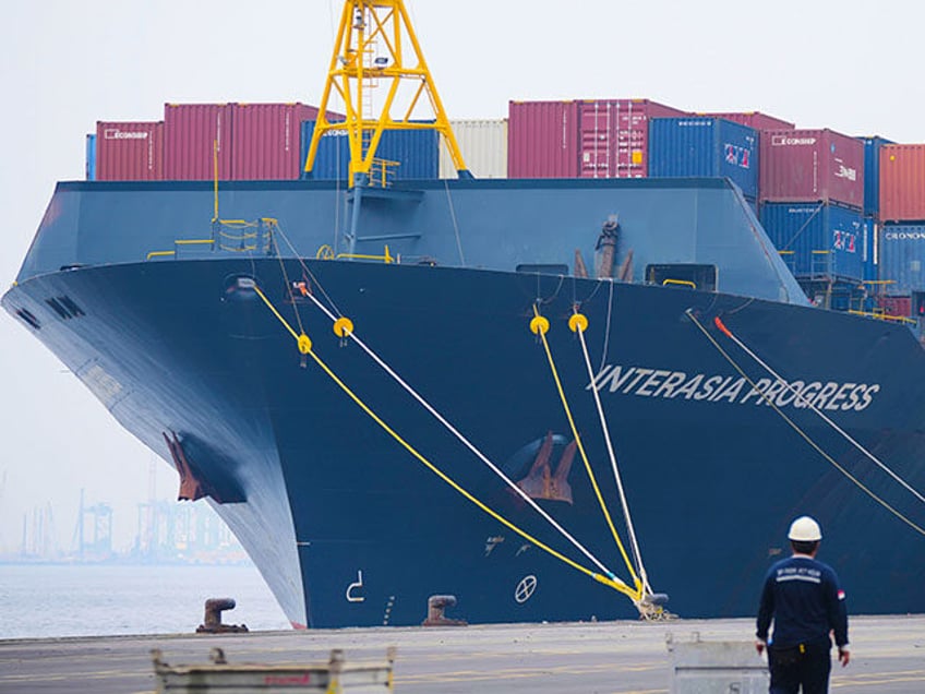 Shipping containers are stacked on a cargo ship docked at Jakarta International Container