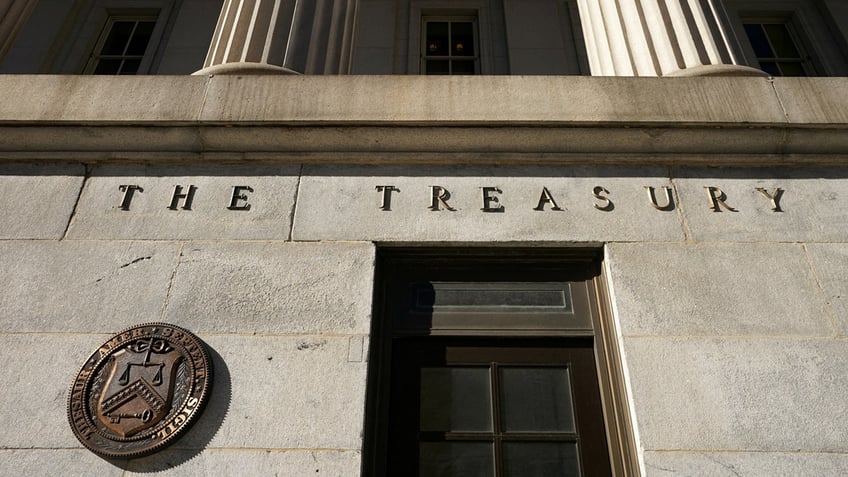 A bronze seal beside a door at the U.S. Treasury building in Washington, D.C.