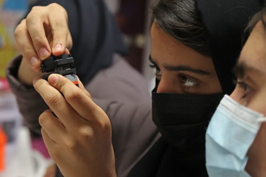 Members of an all-girl Afghan robotics team who fled the Taliban continue their studies in
