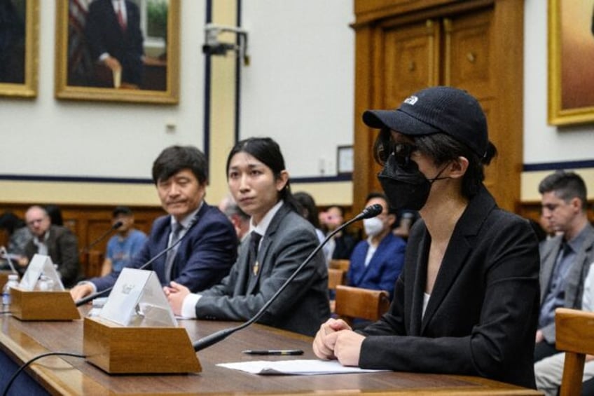 A disguised Columbia University student testifies before the Congressional-Executive Commi