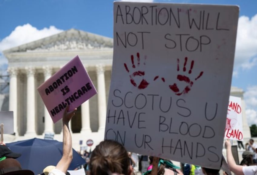 Abortion rights demonstrators rally to mark the first anniversary of the US Supreme Court