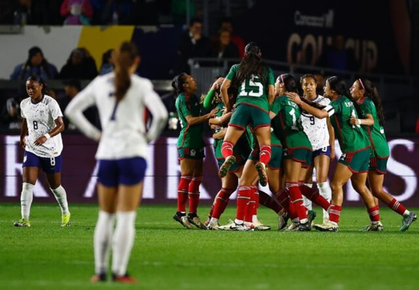 Mexico's players celebrate after their 2-0 upset of the United States at the CONCACAF wome