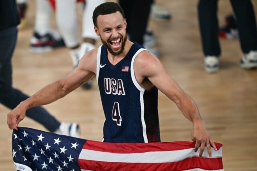 Stephen Curry celebrates after the USA beat France to win basketball gold