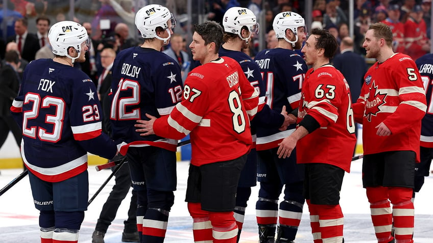 Team USA and Canada shake hands