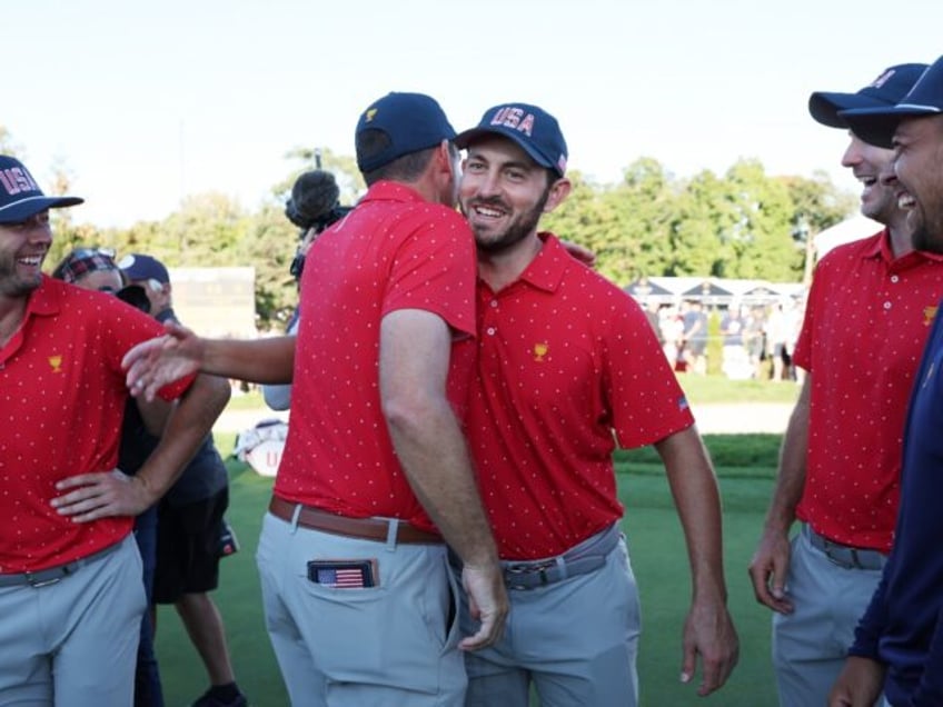 Patrick Cantlay, right center, chest bumps Keegan Bradley as the United States celebrates