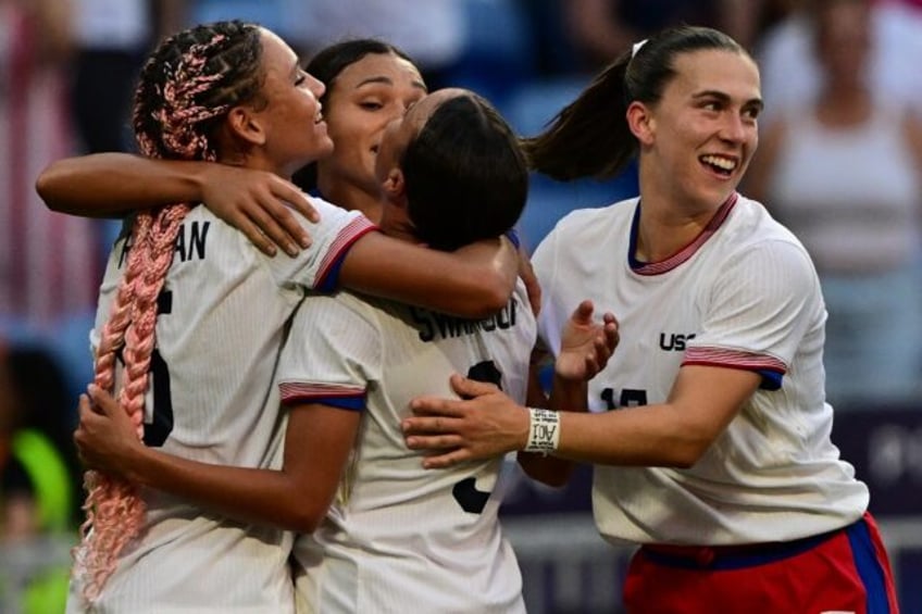 United States players celebrate after Sophia Smith struck the crucial goal in their Olympi