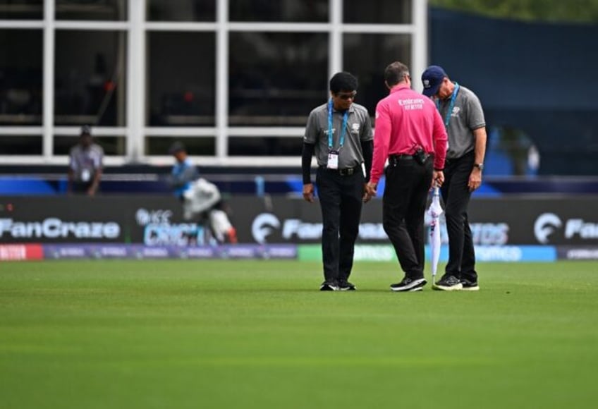Match officials inspect the field before the T20 World Cup group A match between the USA a