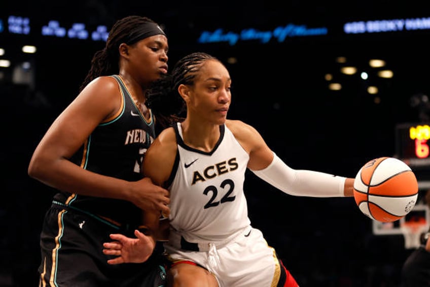 Ja Wilson of the Las Vegas Aces dribbles against Jonquel Jones of the New York Liberty in the fourth quarter during Game Four of the 2023 WNBA Finals...